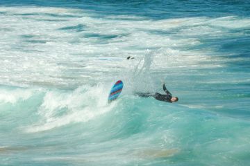 A surfer at the southern end of Bondi Beach gets wiped out while surfing a wave