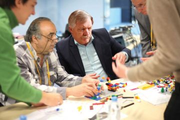 Adults playing with Lego Adults playing with Lego