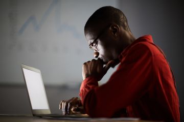African businessman working in dark