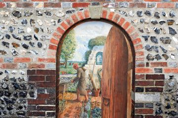 An open door with a painting behind it An open door with a painting behind it