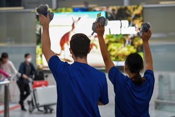 Passengers being greeted from a Singapore Airlines flight as they arrive into the terminal at Sydney Airport on 21 November 2021 in Sydney, Australia. To illustrate the new government being urged to treat overseas students with more compassion.