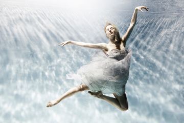 Woman making ballet pose underwater, illustrating that new REF rules ‘risk leaving researchers’ careers in limbo’