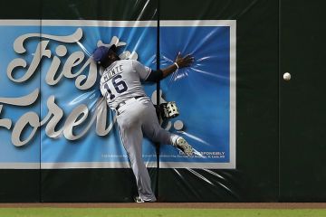 Baseball player running into wall trying to catch ball Baseball player running into wall trying to catch ball