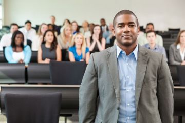 A black academic in a lecture hall