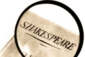 Book by Shakespeare under a magnifying glass Book by Shakespeare under a magnifying glass