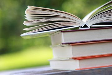 Books open on table outside Books open on table outside