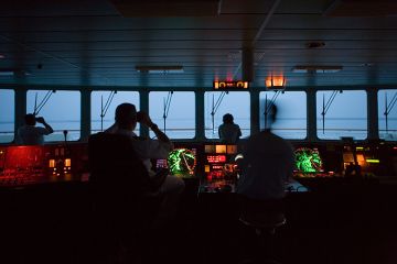 Captain and officers in silhouette looking out of window in the bridge of a ship. To illustrate the search is on for a new chief executive to lead the Office for Students. Captain and officers in silhouette looking out of window in the bridge of a ship. To illustrate the search is on for a new chief executive to lead the Office for Students.