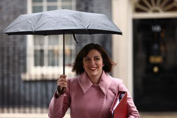 Bridget Phillipson holds an umbrella