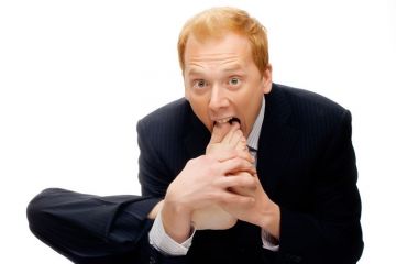 Businessman with foot in mouth Businessman with foot in mouth