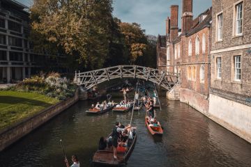 Punting on a crowded river in Cambridge, illustrating bullying and precarity