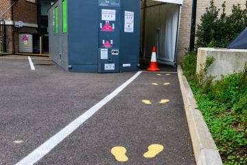 Cambridge UK, England ,24-11-2020, Painted footprints on asphalt outside University covid test station. The University offers swab tests to College and University staff and students displaying symptoms