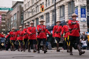 Vancouver, BC, Canada – November 11, 2016: RCMP officers, dressed in ceremonial red serge, march through downtown Vancouver for Remembrance Day.