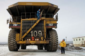Canadian workmen operating large construction vehicle Canadian workmen operating large construction vehicle