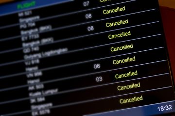 An airport departure board with lots of flights cancelled An airport departure board with lots of flights cancelled illustrating an opinion article about cancel culture