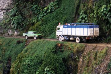 Cars confront on thin Andes road Cars confront on thin Andes road