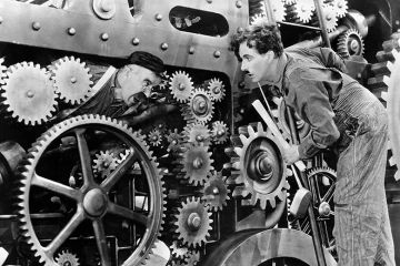 Charlie Chaplin and another actor in a scene from the movie "Modern Times." Movie released in 1936. To illustrate how automated university systems ‘make administrative burden worse’