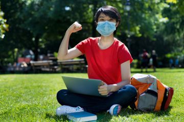 Cheering student wearing face mask