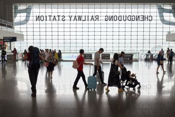 Chengdu, China - October 01, 2017 Passengers silhouettes inside the Chengdu railway station modern building.