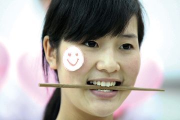 Woman with chopstick in her mouth Woman with chopstick in her mouth