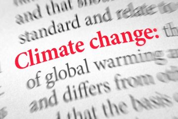 A book containing a definition of climate change illustrating an op-ed about an exhibition bringing humanities and sciences together during. COP26