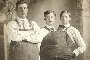 Two men close together wearing same clothes Two men close together wearing same clothes