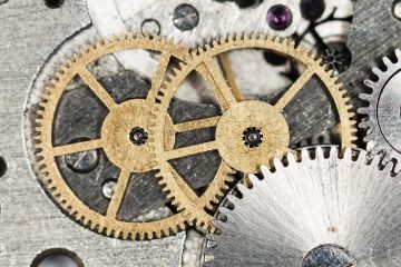 Two cogwheels driving a mechanism, symbolising innovation Two cogwheels driving a mechanism, symbolising innovation