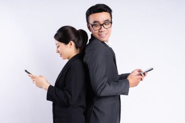 Two Asian business people on their phones