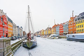 Copenhagen, Denmark - January 5, 2011 Nyhavn (New Harbor)in winter. It is waterfront, canal, entertainment district in Copenhagen in Denmark. It is lined by colorful houses, bars, cafes, wooden ships