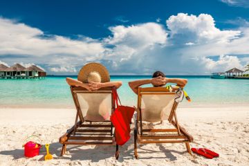 Couple on sun loungers