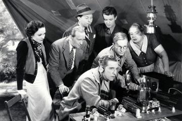 Crowd of people listening to-two way radio