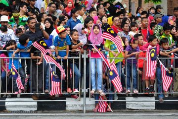 Crowd of people waving Malaysian flags Crowd of people waving Malaysian flags