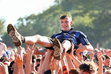  A music fan wearing a crown crowd surfs at the TRNSMT Festival. To illustrate academic communities in all parts of the UK helping rising stars of humanities and social sciences to shine.