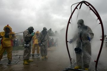 A person in a chemical protection suit walks through a decontamination shower as another is washed down during a mock chemical attack. To illustrate researchers might need to demand retraction of their own papers to decontaminate scientific literature. A person in a chemical protection suit walks through a decontamination shower as another is washed down during a mock chemical attack. To illustrate researchers might need to demand retraction of their own papers to decontaminate scientific literature.