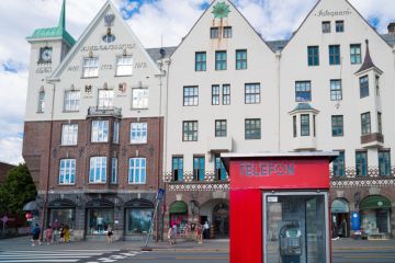 Detail of a red phone booth on the Bryggen promenade, the touristic hotspot of Bergen
