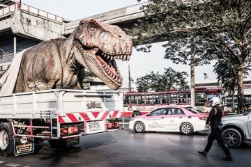 A huge plastic dinosaur in the back of a lorry