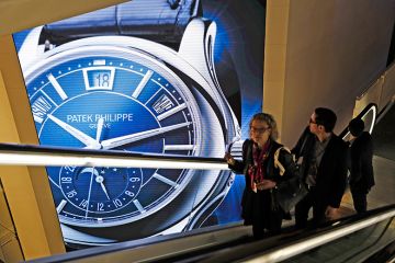 Visitors traveling on an escalator pass a Patek Philippe luxury wristwatch advertisement. To illustrate that there has been an increase in the number of staff paid more than £100,000 at Russell Group universities. Visitors traveling on an escalator pass a Patek Philippe luxury wristwatch advertisement. To illustrate that there has been an increase in the number of staff paid more than £100,000 at Russell Group universities.