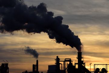 Smoke billows from factory chimneys