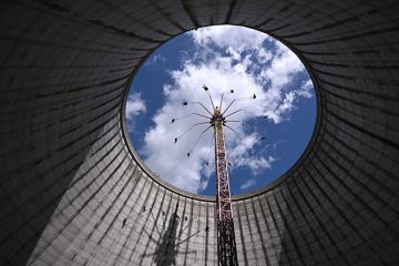Visitors on a fairground ride rising into the sky from what was a nuclear fast breeder, at the amusement park in Kalkar, Germany, 2023. To illustrate German excellence strategies boosting the research capacity of its top institutions.