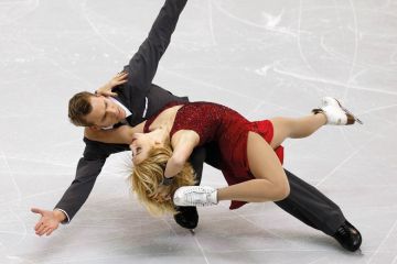 Figure skaters striking pose during competition Figure skaters striking pose during competition