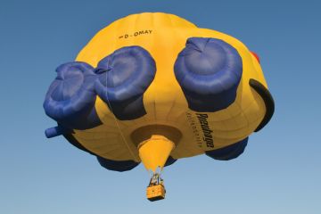 Flying hot-air balloon shaped as car, Rhineland-Palatinate, Germany Flying hot-air balloon shaped as car, Rhineland-Palatinate, Germany