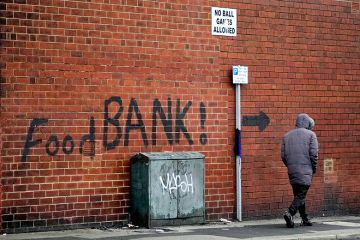 A sign painted on the side of a house directs people to a local food bank in Leeds, England. To illustrate the cost-of-living pressures that affect postgraduate researchers. A sign painted on the side of a house directs people to a local food bank in Leeds, England. To illustrate the cost-of-living pressures that affect postgraduate researchers.