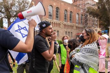 An Israeli man, holding a flag, argues with a pro-Palestinian student as pro-Palestinian students gather to protest against Israeli attacks on Gaza at University of California (UCLA) in Los Angeles, California, United States on April 25, 2024 An Israeli man, holding a flag, argues with a pro-Palestinian student as pro-Palestinian students gather to protest against Israeli attacks on Gaza at University of California (UCLA) in Los Angeles, California, United States on April 25, 2024