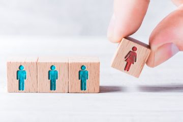 A cube with a woman on it being added to three with men on them, symbolising gender equality