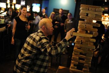Troy Benson eases a block out an oversized Jenga game