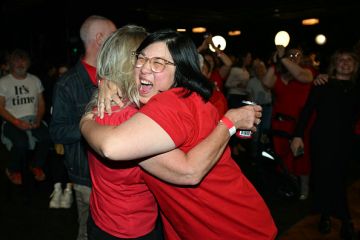 Labor Party supporters react as national broadcaster ABC projected a win for the party