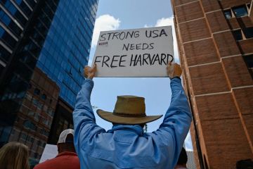 Harvard alumni, students and faculty protest the federal administration cuts outside of the Boston Moakley Federal District Courthouse