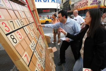 Jim Ressler, owner of Sudoku Board USA, helps Dorris Lam of Glen Rock, N.J., solve a Sudoku puzzle on a gigantic board in Times Square Jim Ressler, owner of Sudoku Board USA, helps Dorris Lam of Glen Rock, N.J., solve a Sudoku puzzle on a gigantic board in Times Square