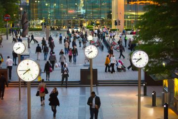 Canary Wharf business life. Business people leaving offices and going home after working day