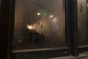 Handprint On Smoked Pub Window Glass