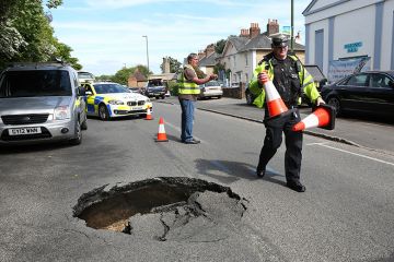 Police and workers put cones around sink hole in road. To illustrate that ResearchPlus must carve out a distinctive niche to avoid falling into the pitfalls of its predecessors.